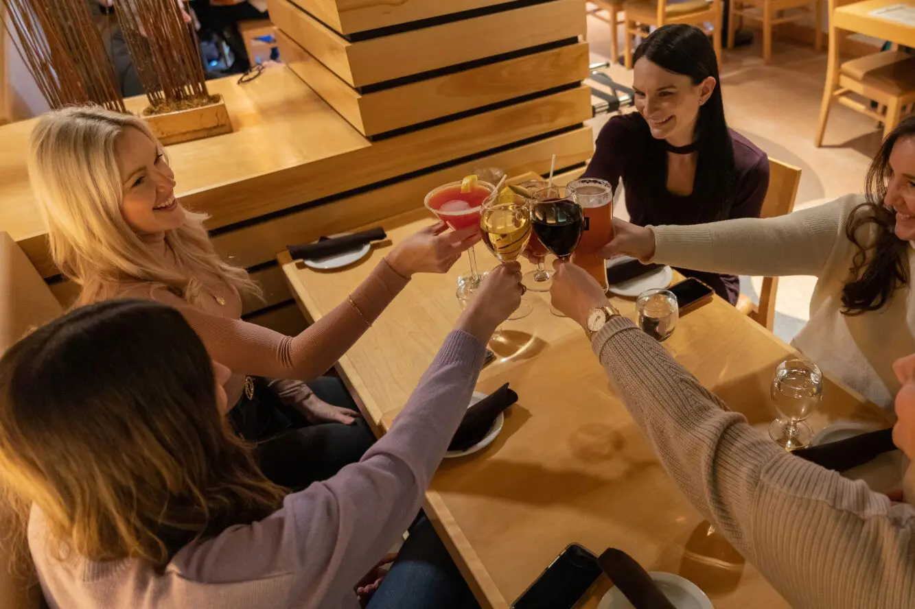 A group of people sitting at a table with drinks.